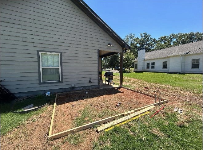 Concrete patio installation before work by Limitless Construction Services