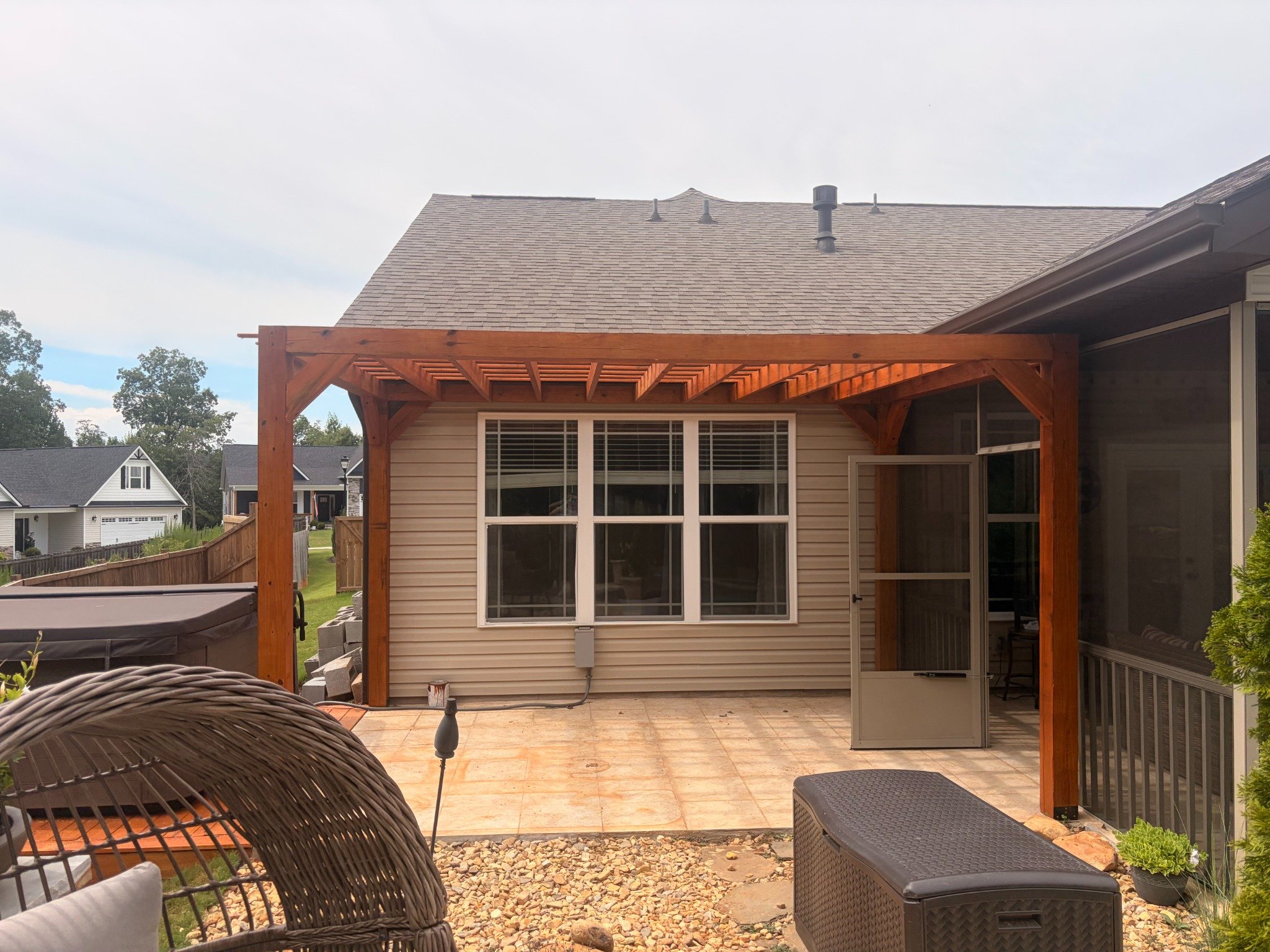 Pergola overhead rafter structure attached to home by Limitless Construction Services