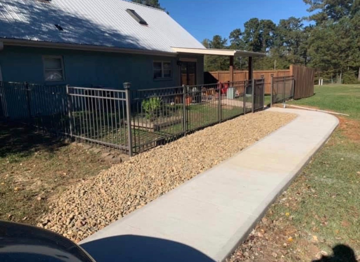 Concrete walkway and gravel border installation by Limitless Construction Services
