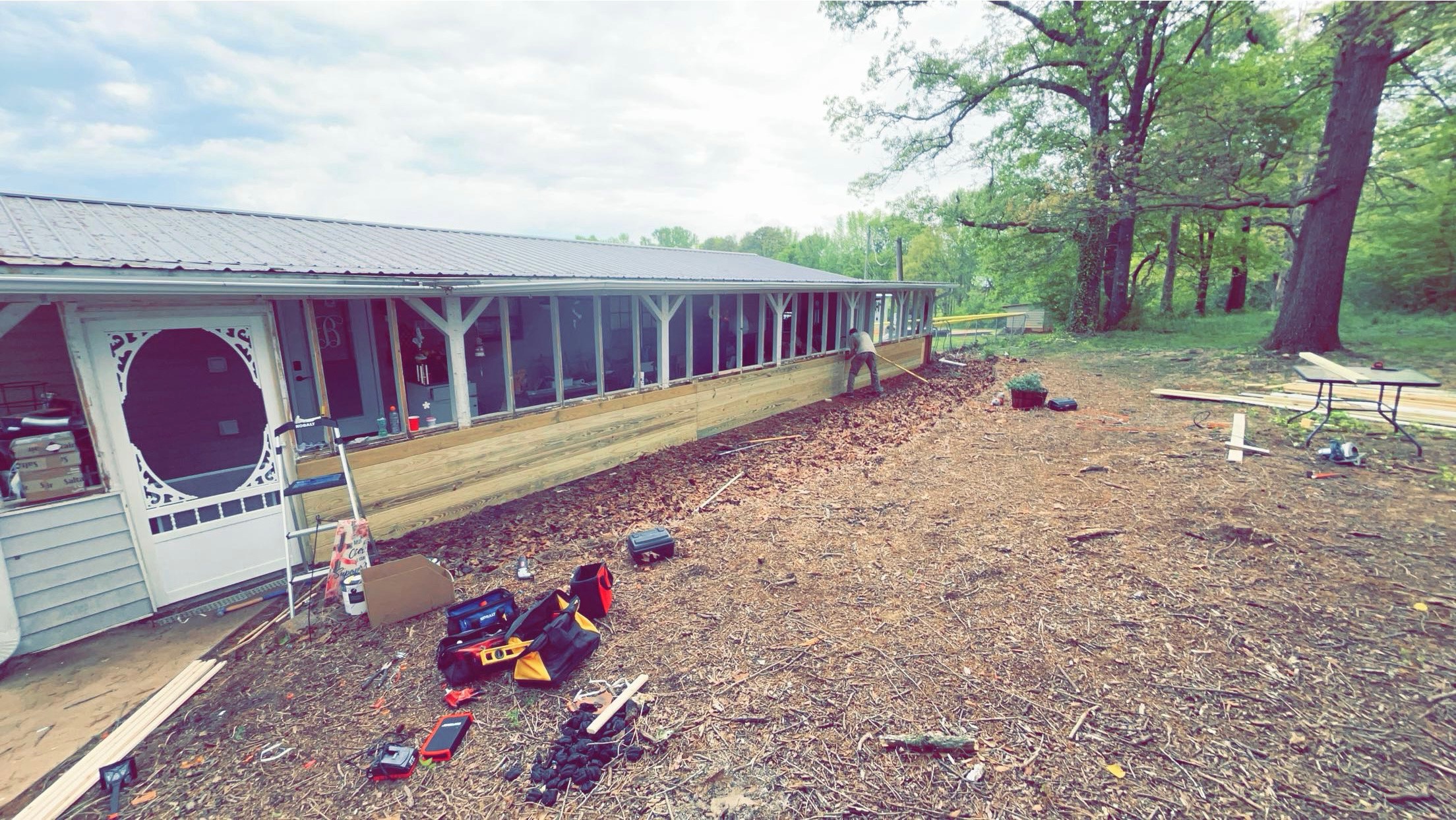 New wood framing and siding installation in progress on screened porch by Limitless Construction Services