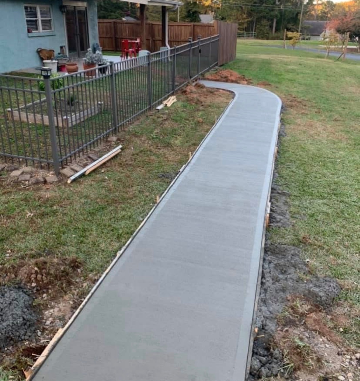 Curved concrete walkway pouring and finishing by Limitless Construction Services