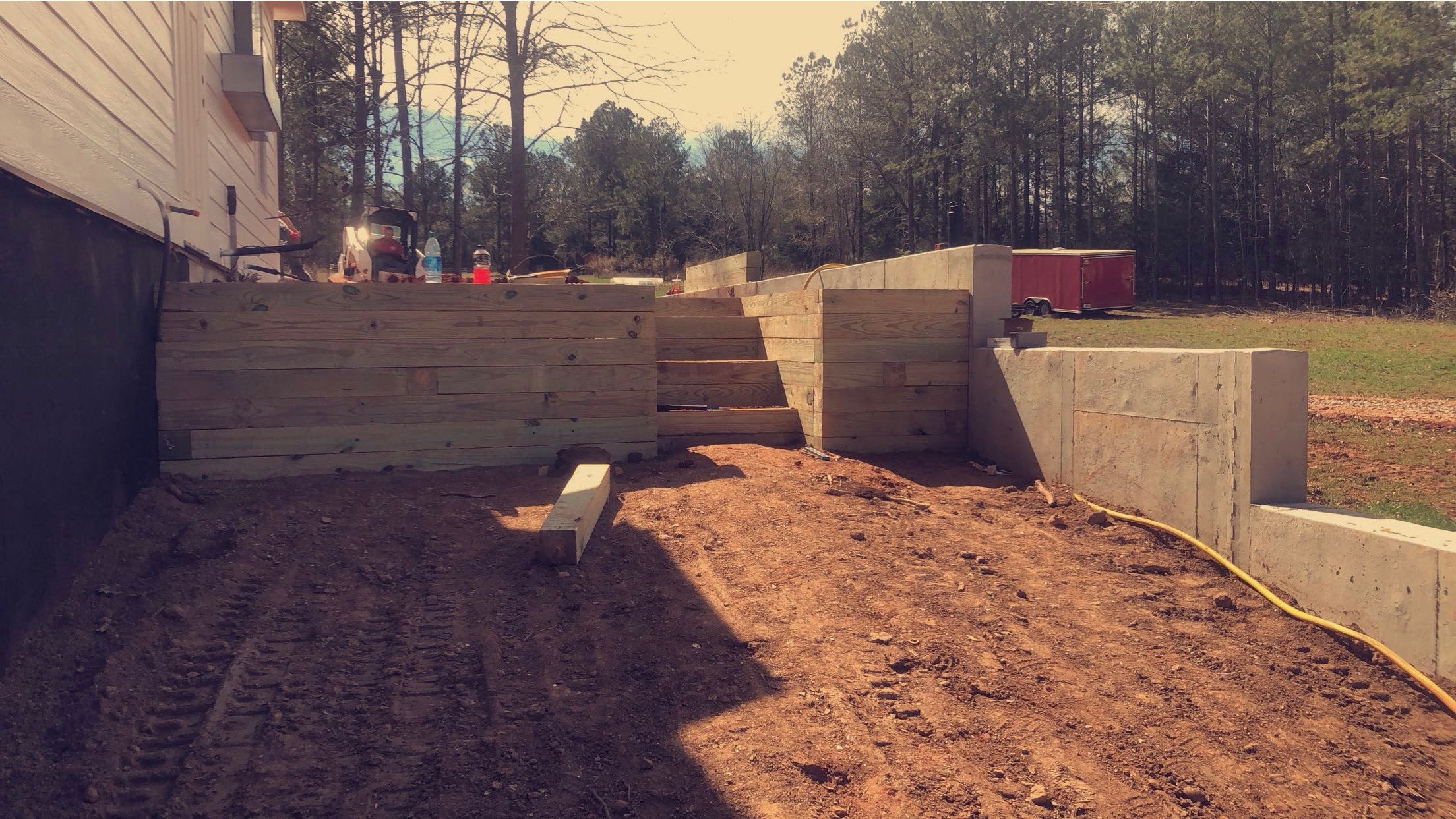 Wider perspective of tiered retaining walls and stairs construction by Limitless Construction Services