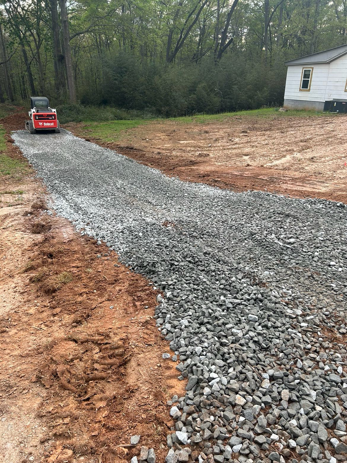 Gravel driveway and site preparation work with Bobcat by Limitless Construction Services