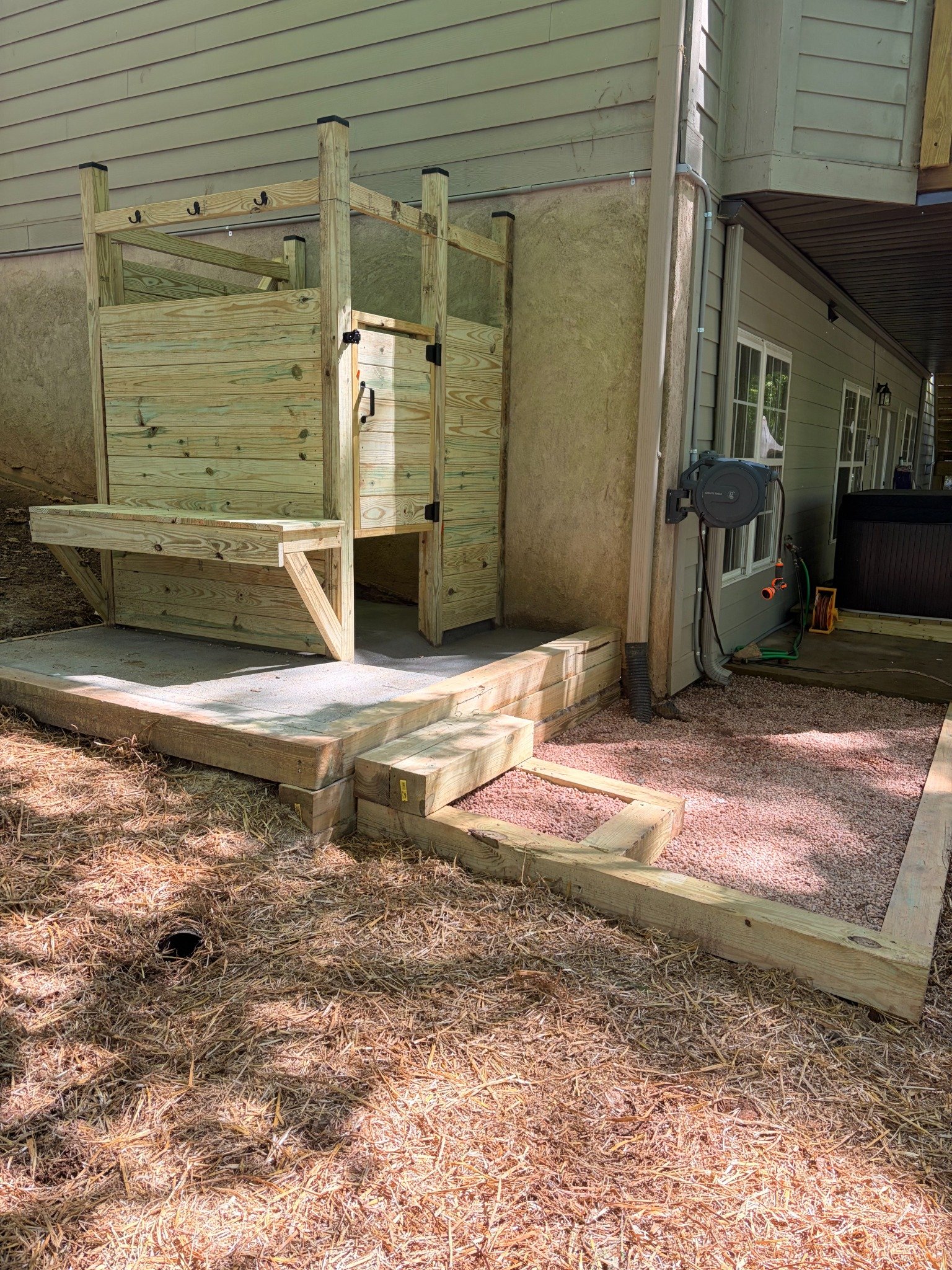 Custom outdoor privacy enclosure and gravel landing by Limitless Construction Services