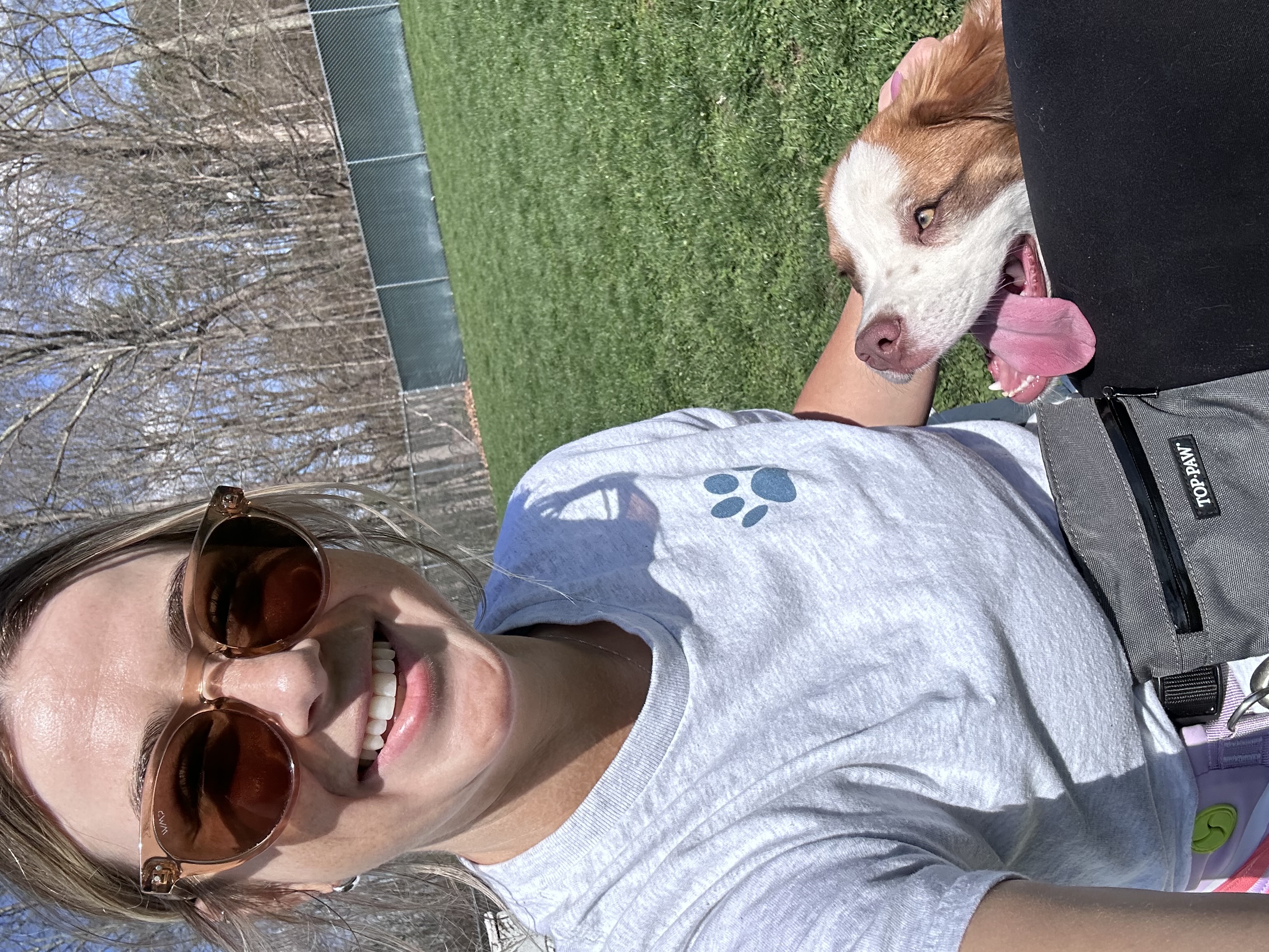 Alex, founder of Allywags, smiling with a dog