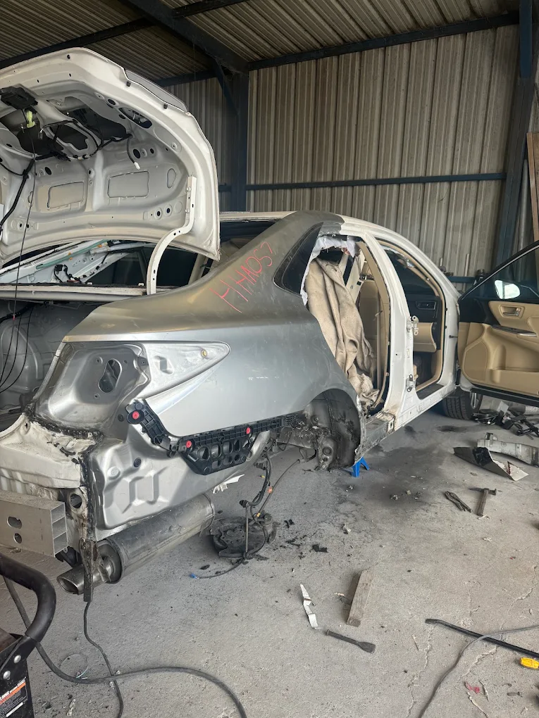 Severe rear quarter panel collision teardown and frame rebuilding in shop
