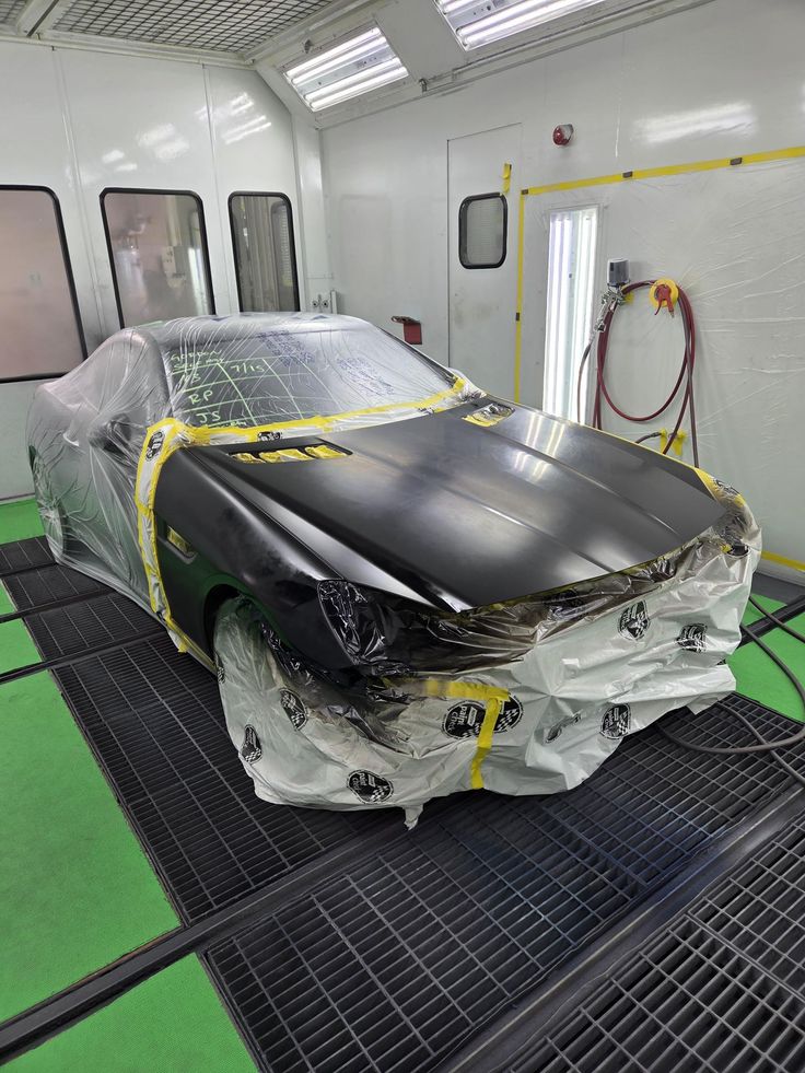 Vehicle masked and prepped in professional paint booth at AZ Auto Repair