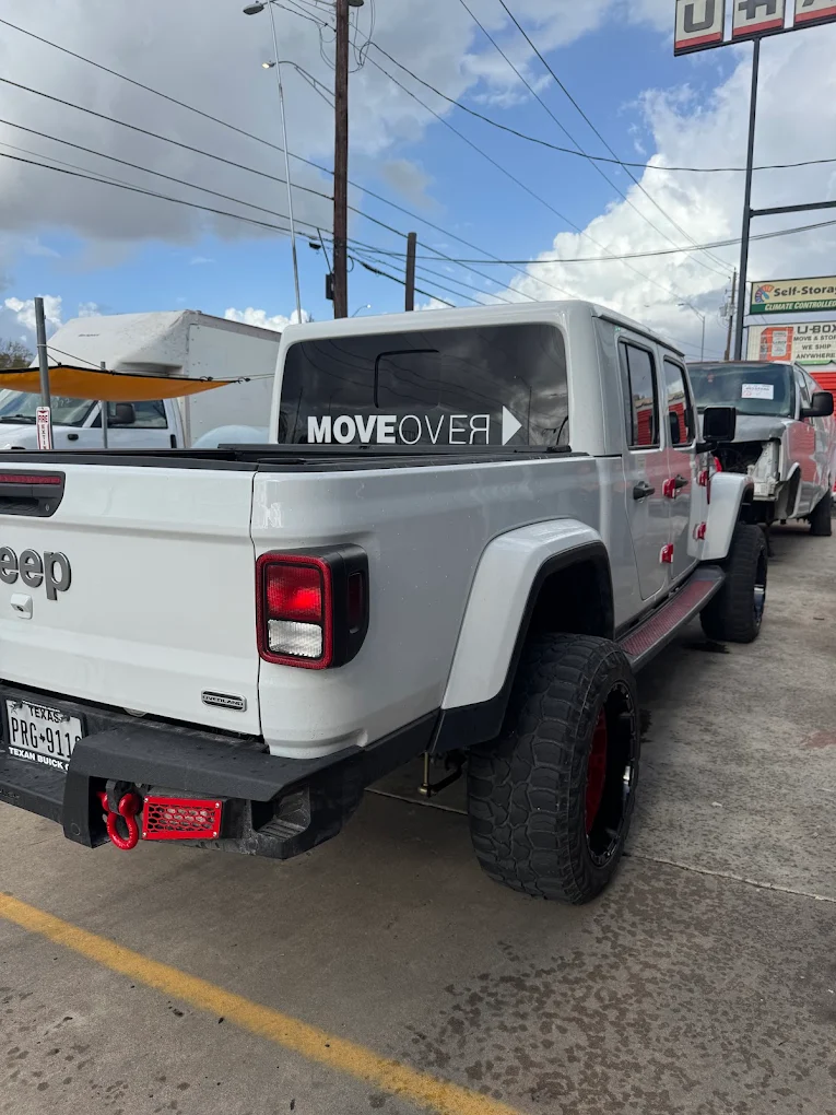 White Jeep Gladiator Overland with custom accents parked outside AZ Auto Repair