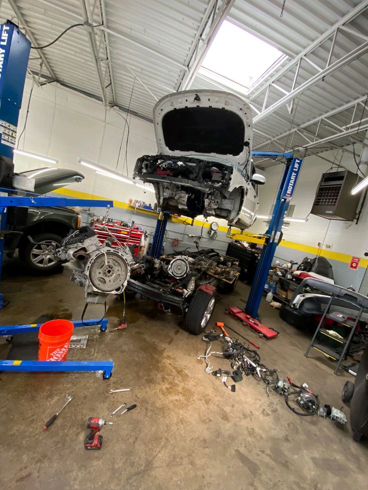 Santos, owner of AZ Auto Repair, standing confidently in his Houston auto body shop