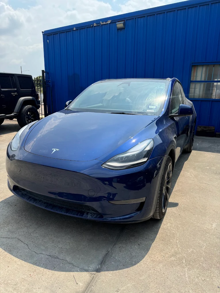 Blue Tesla Model Y after body repair outside AZ Auto Repair facility