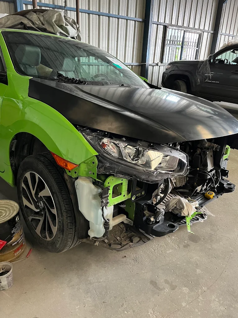Bright green Honda Civic front end disassembly and custom hood fitting in bay