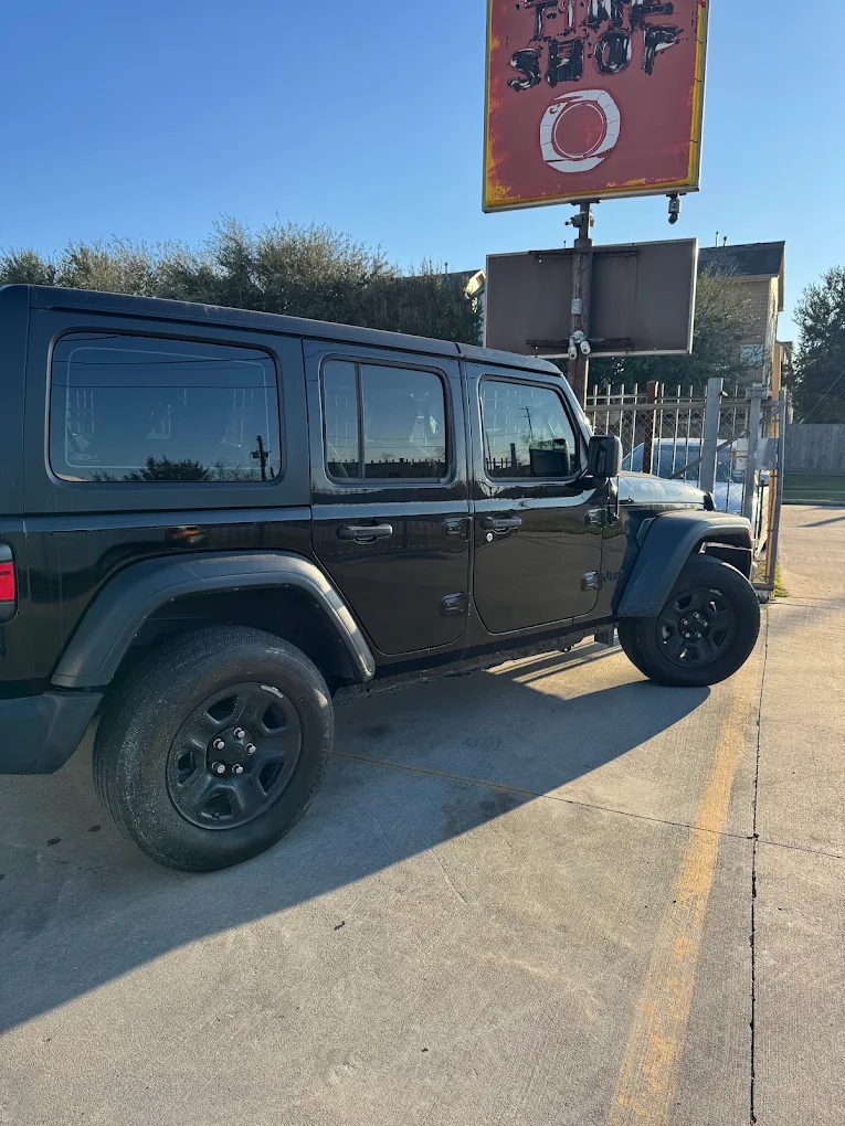 Black Jeep Wrangler parked outside AZ Auto Repair after completed body repairs