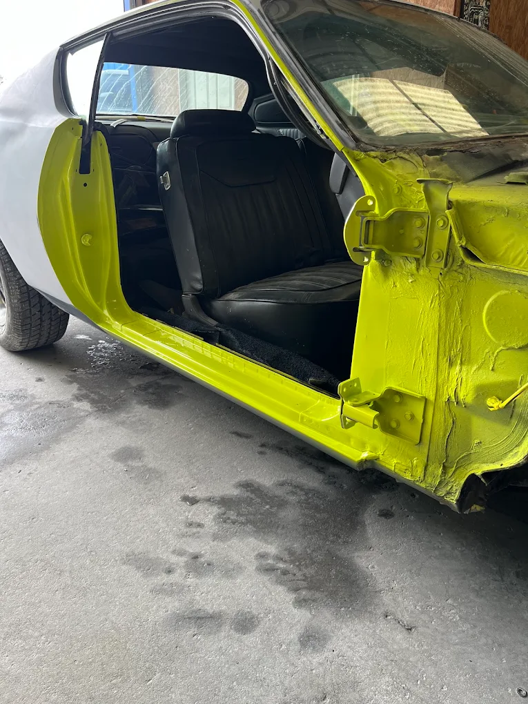 Classic muscle car door jambs painted custom lime yellow during restoration