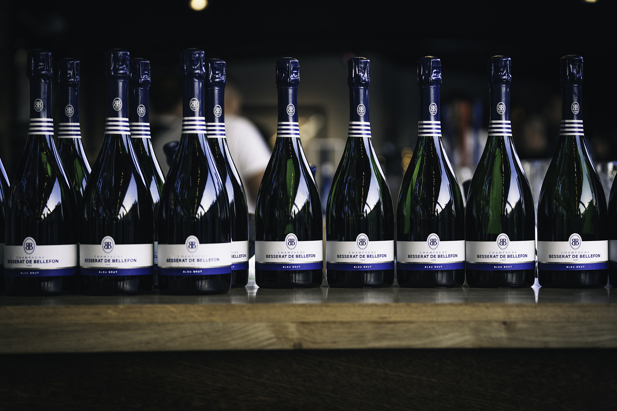 A line of Besserat de Bellefon Bleu Brut bottles