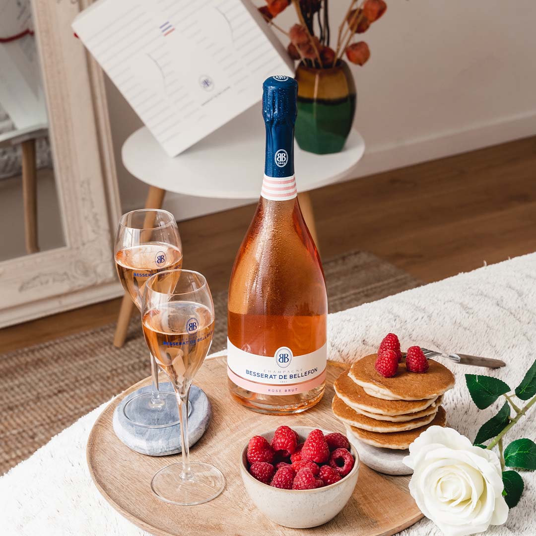 Besserat de Bellefon Rosé Brut with glasses and fresh raspberries