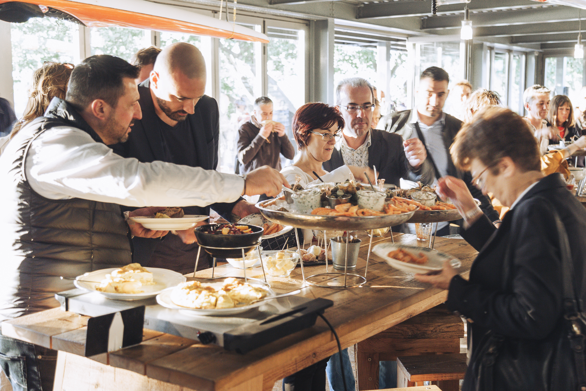 Guests sharing food and Champagne around a dining table