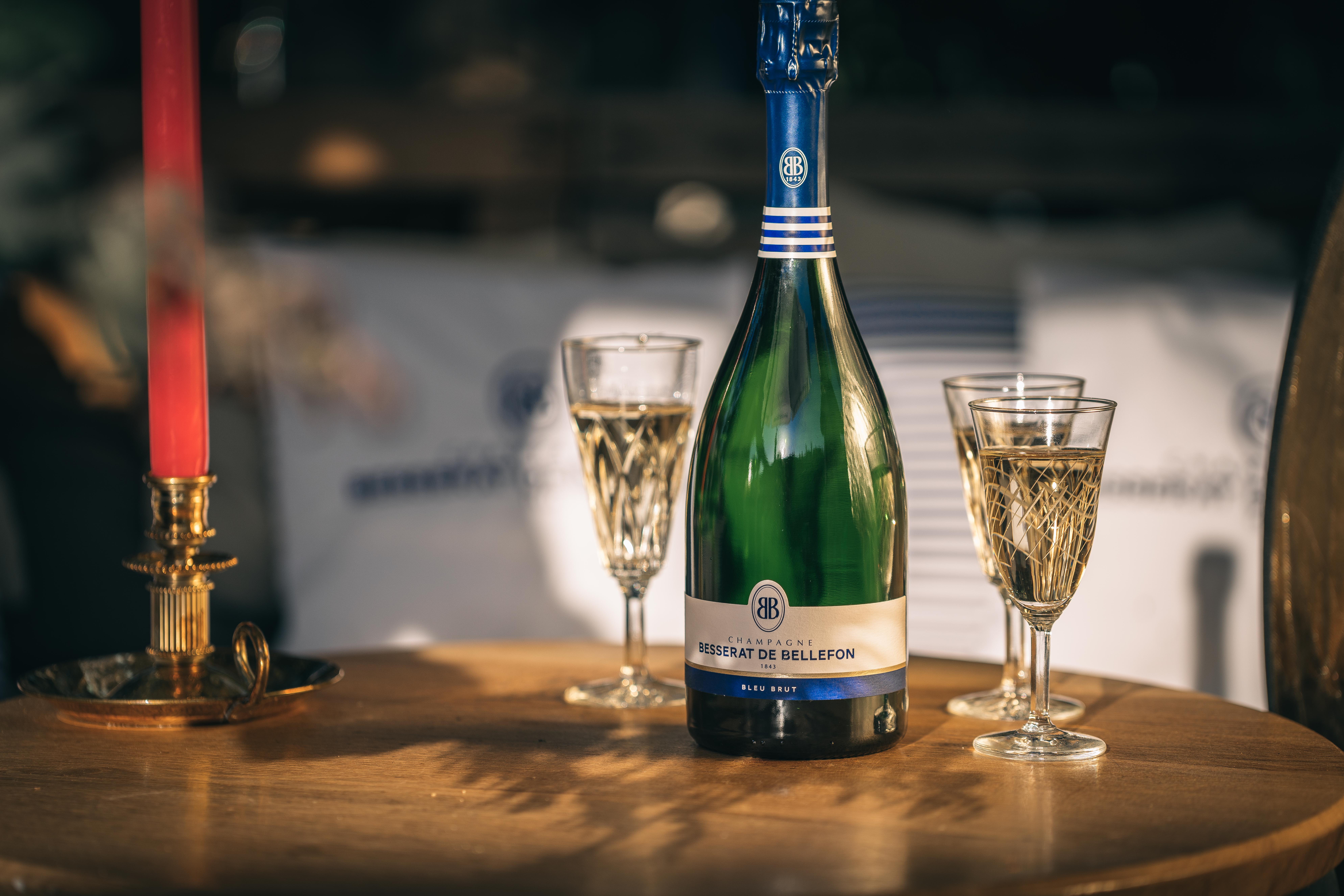 Besserat de Bellefon Champagne with two glasses on a warmly lit table