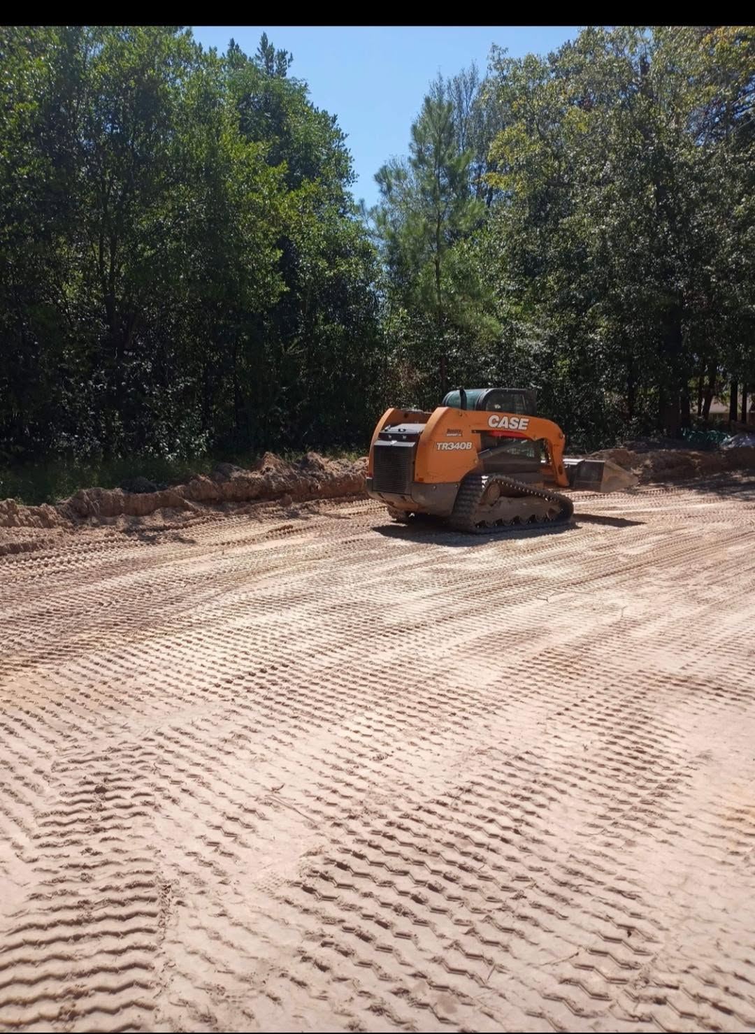Breaking Ground CASE skid steer grading and preparing a dirt surface
