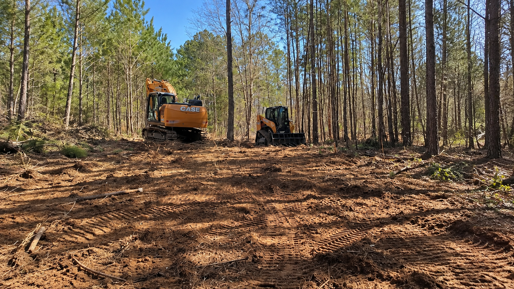 CASE excavator and compact track loader handling heavy site excavation and clearing in Augusta, GA