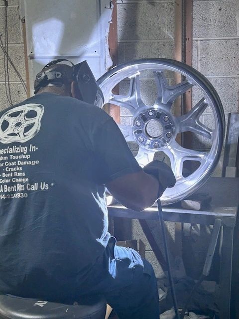 Technician TIG welding a cracked wheel rim at Cleveland Rim Repair