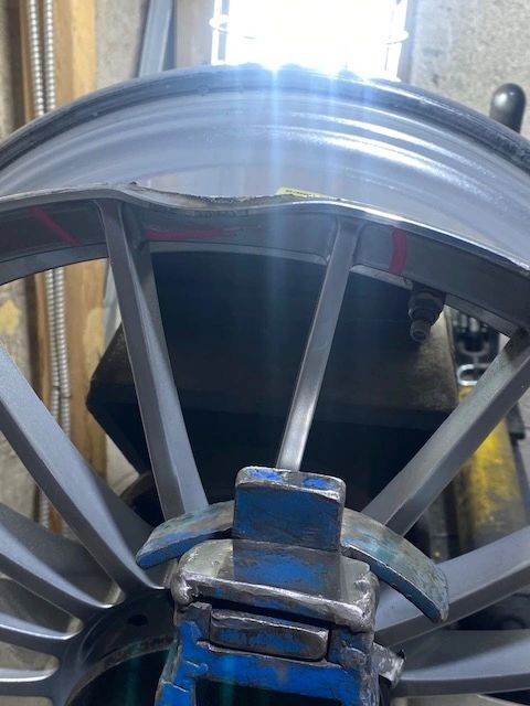 Technician straightening a bent wheel at Cleveland Rim Repair