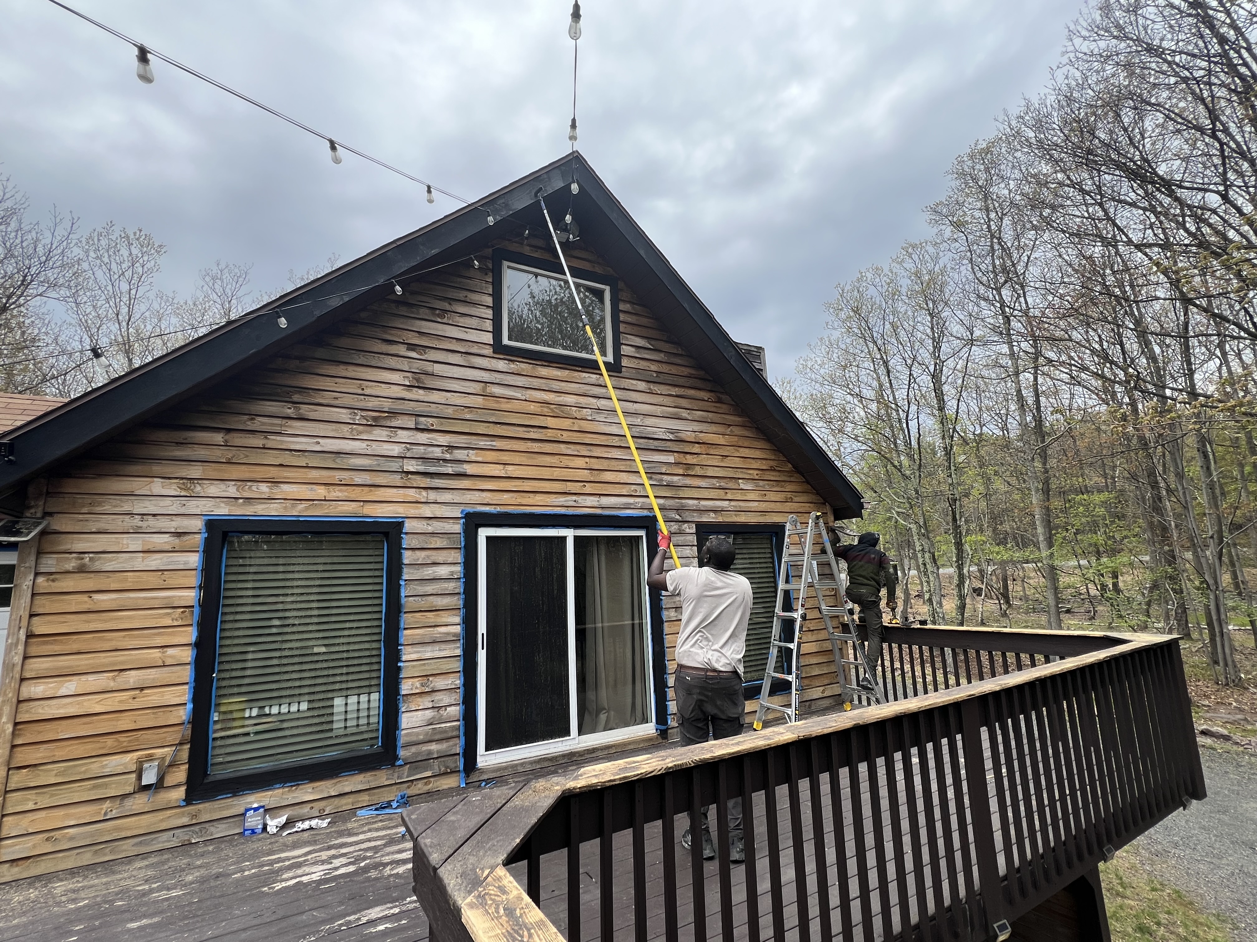 Poconos Main House before staining — weathered wood siding and deck during prep work