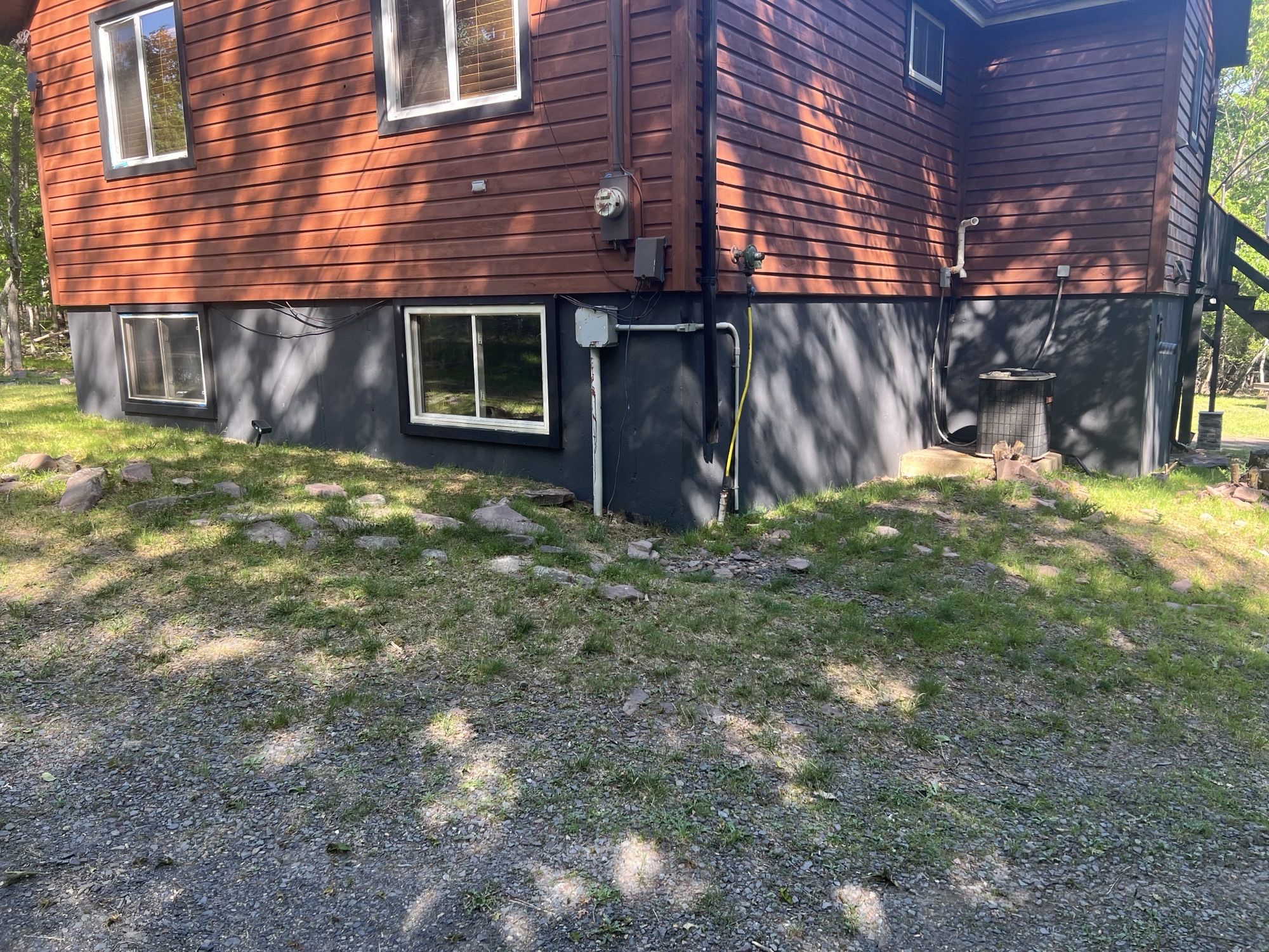 Poconos cabin after renovation — completed side exterior wall and painted foundation