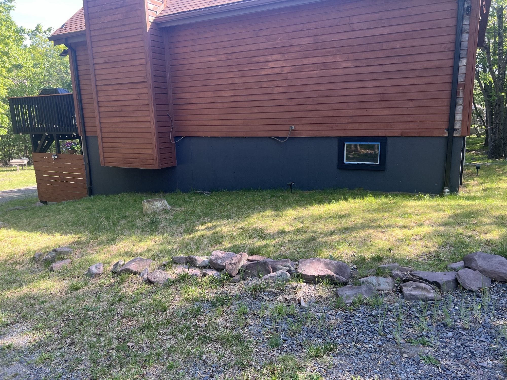 Poconos cabin after renovation — finished chimney wall and foundation view