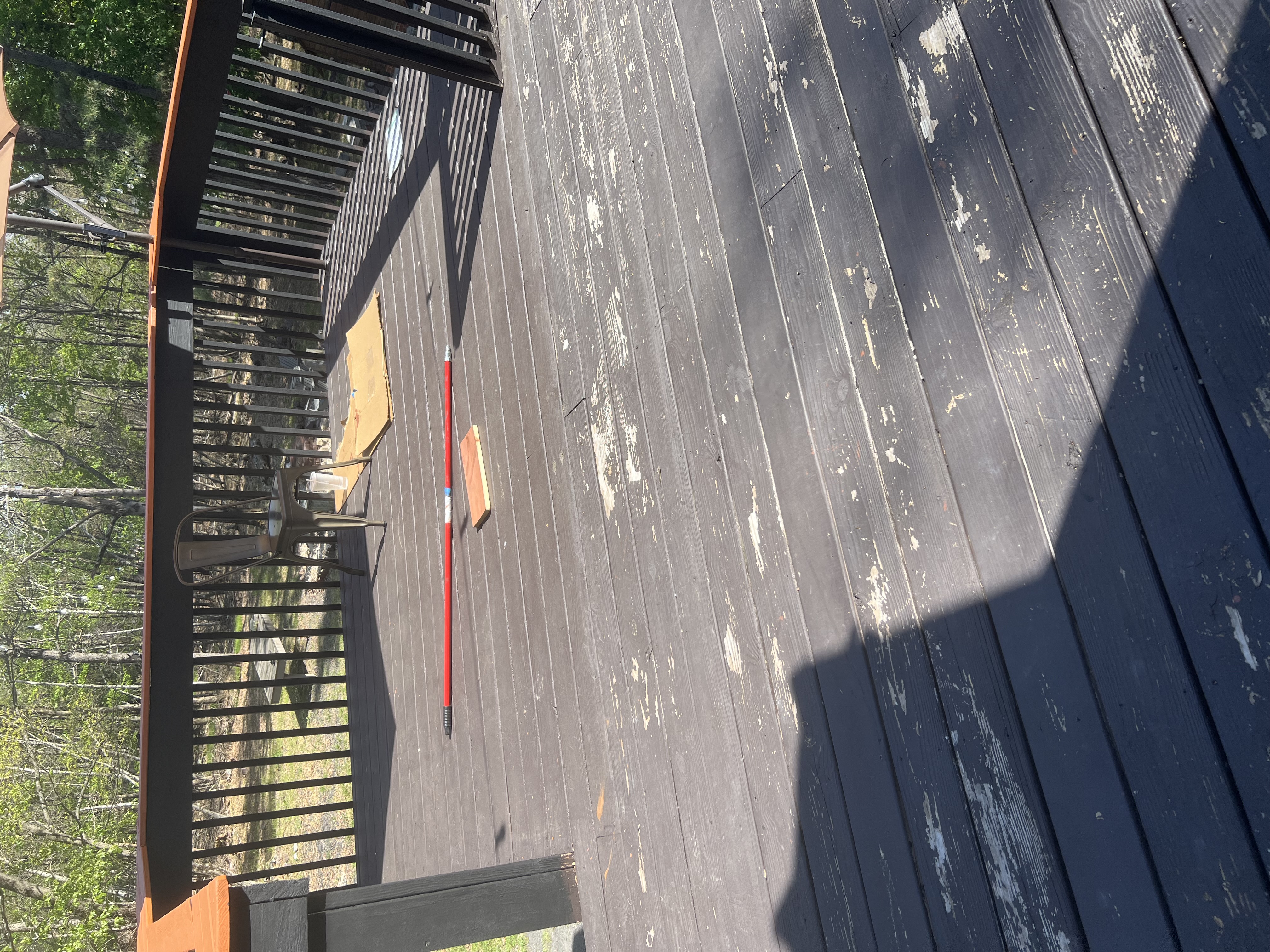 Poconos cabin before renovation — weathered deck floor with severely peeling paint and stain