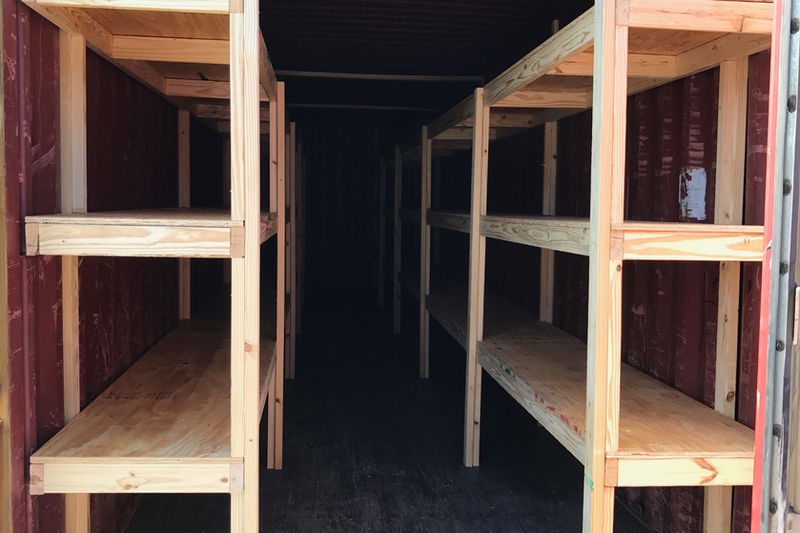 Custom wood shelving buildout inside storage unit