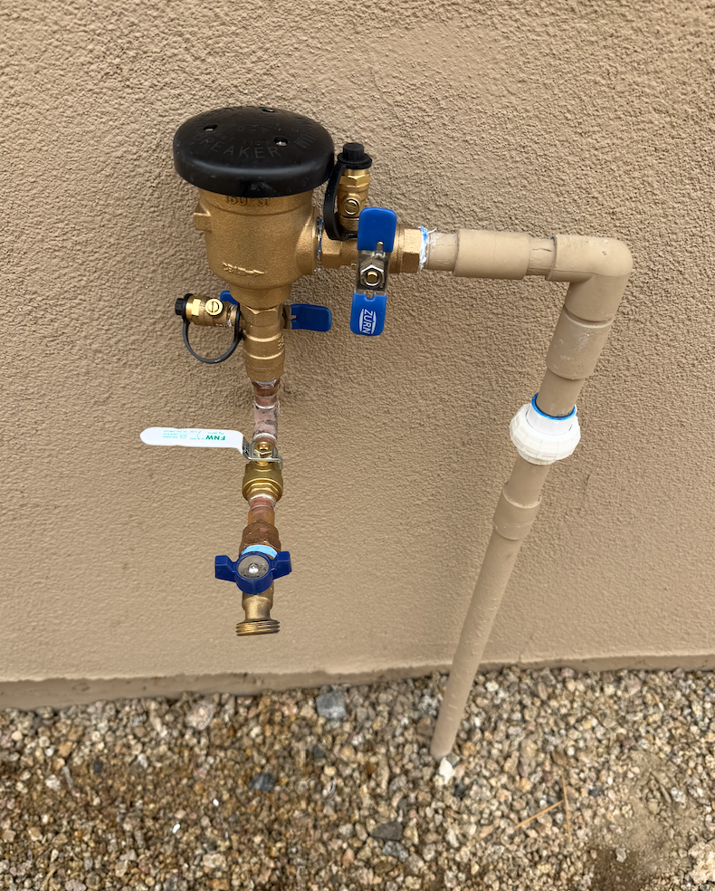 Outdoor pressure vacuum breaker and dedicated water supply line connection installed by Aurora Plumbing
