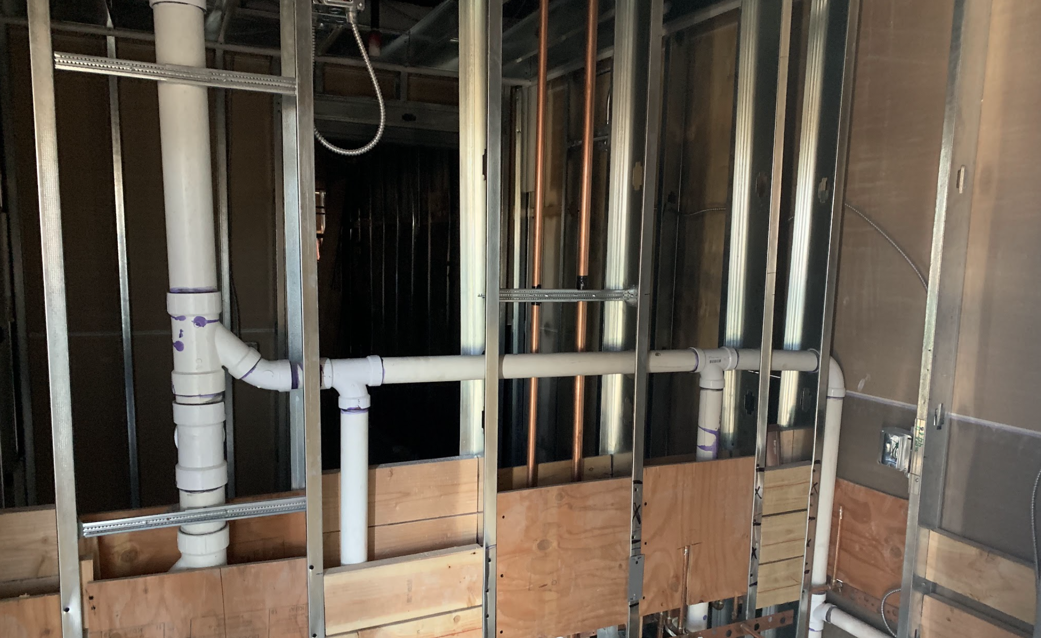 New copper water main line installed in a trench beside a stucco home in Peoria, AZ