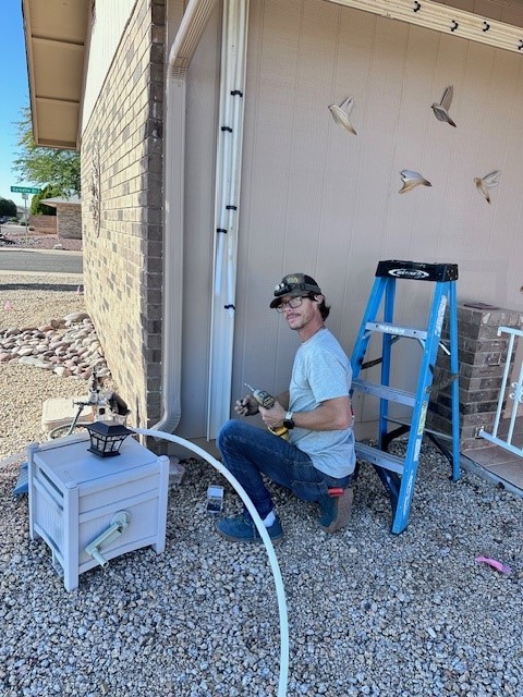 Dave Danberg of Aurora Plumbing working on residential plumbing lines outside a Glendale, AZ home