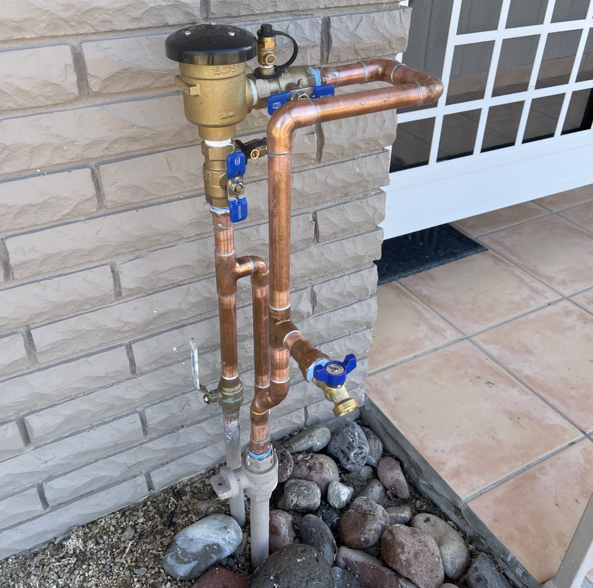Outdoor backflow preventer and copper plumbing installation by Aurora Plumbing in Phoenix, AZ