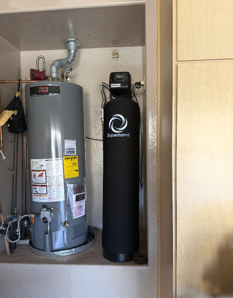 Newly installed water conditioning system with connected pipes in a Peoria, AZ home garage