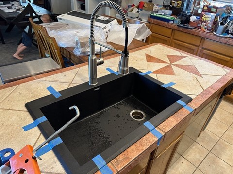 Black composite kitchen sink and pulldown faucet installation by Aurora Plumbing in Peoria, AZ