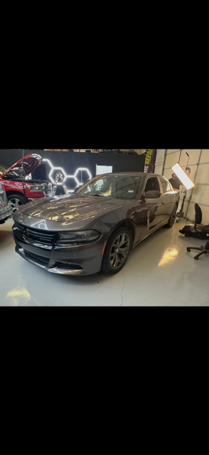 Hail Deals technician inspecting vehicle for hail dents