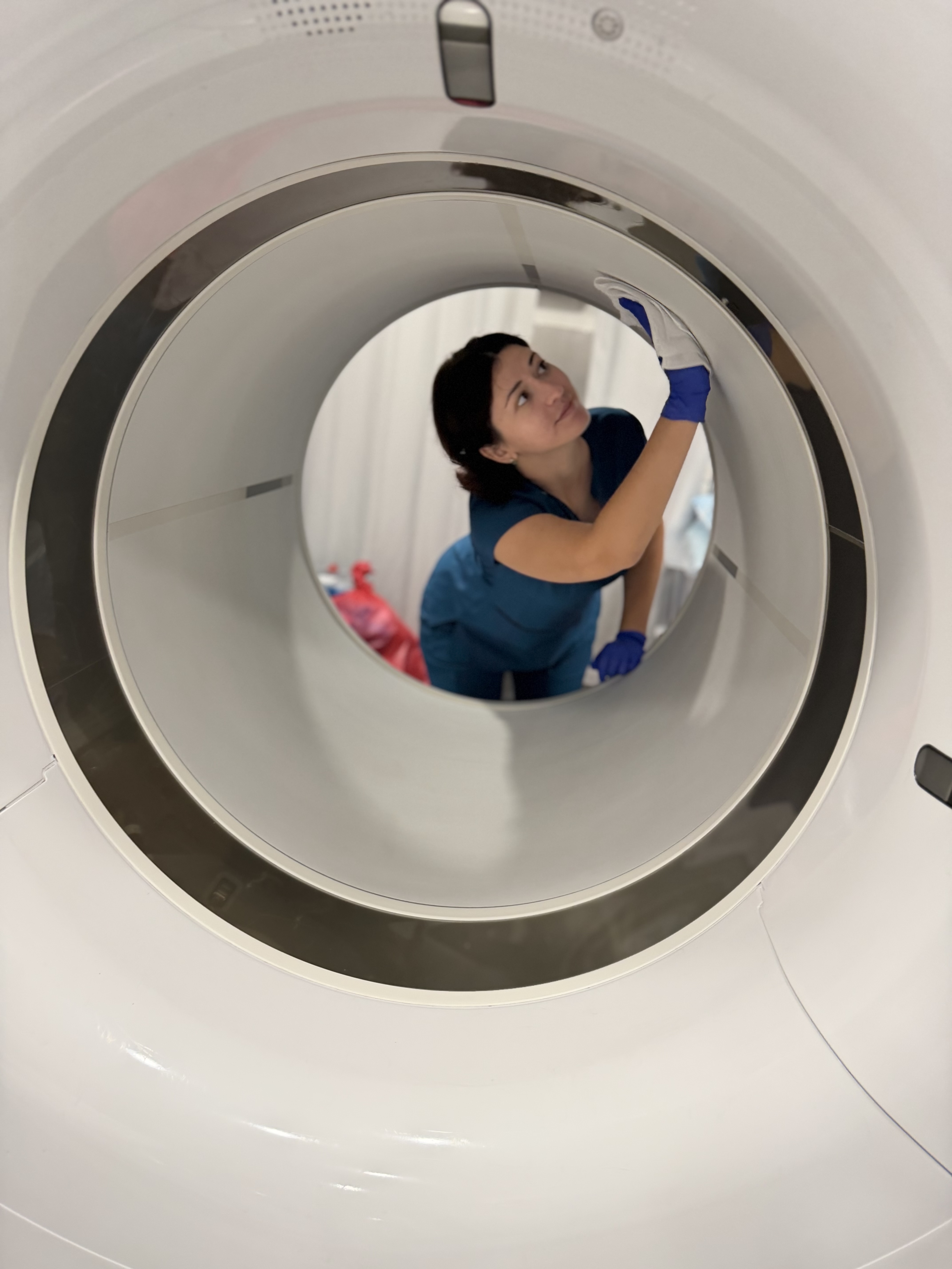 AiM Imaging Care specialist performing precision cleaning inside an MRI bore