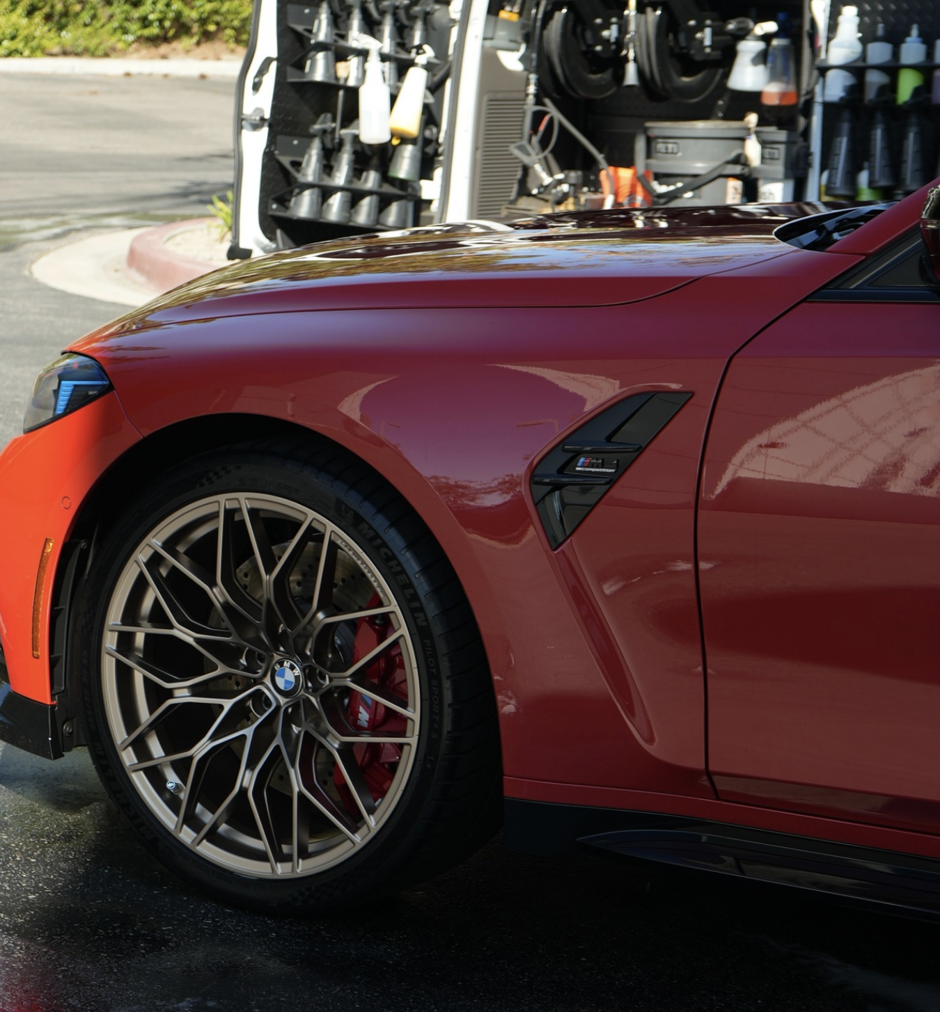 Polished vehicle beside professional mobile detailing equipment.