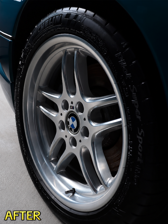 Clean, polished BMW alloy wheel and dressed tire after mobile detailing in Savannah
