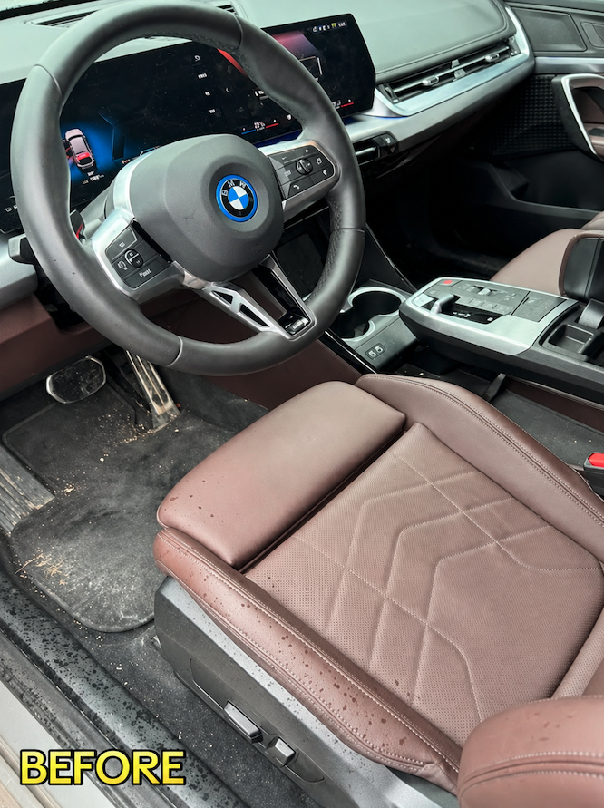 Soiled BMW front interior and leather driver seat before mobile detailing in Savannah