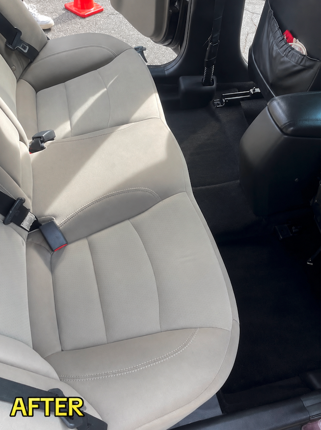 Fully decluttered, vacuumed, and deep-cleaned rear seating area after mobile detailing
