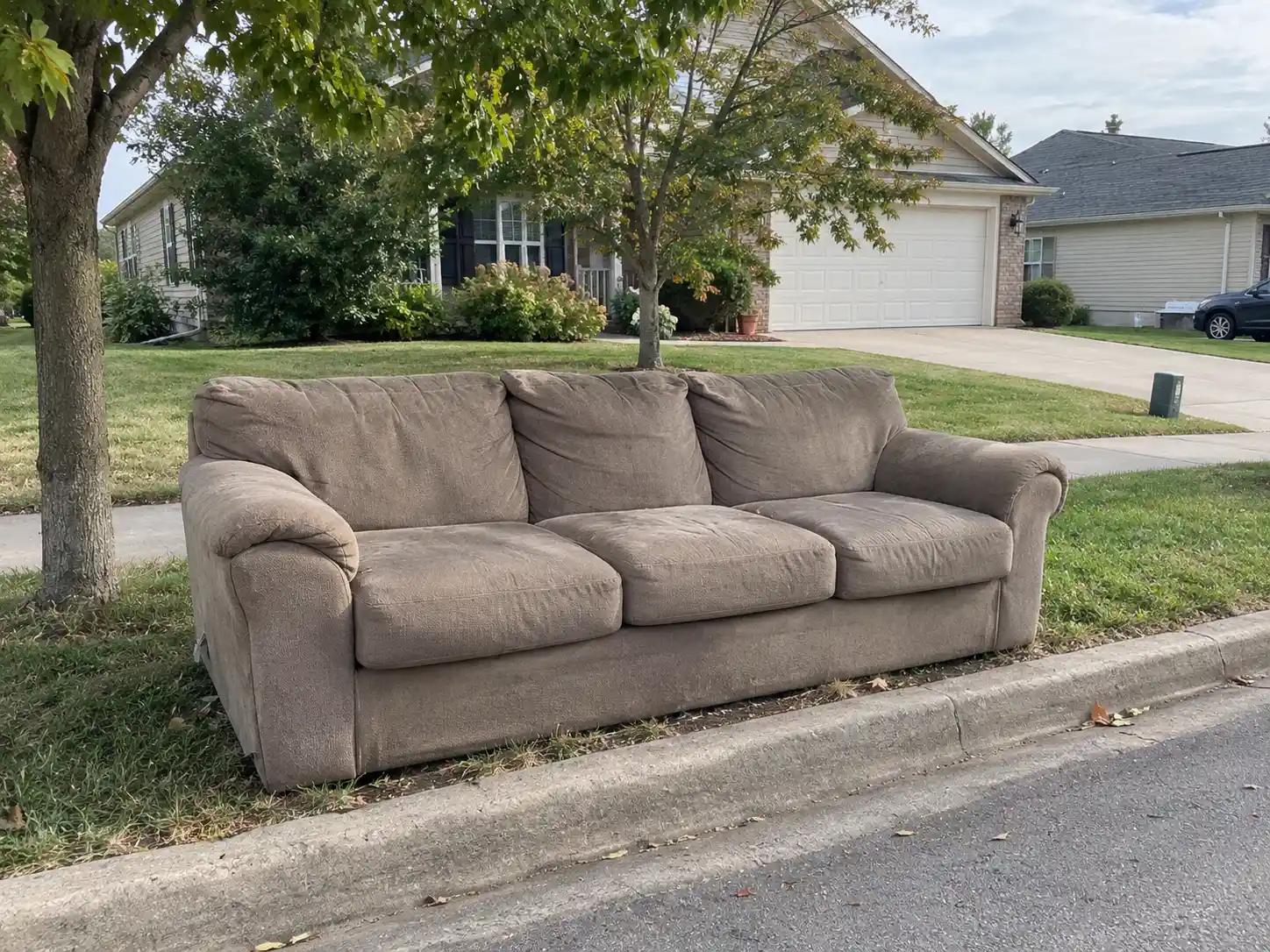 Old couch set out for furniture removal in St. Charles, MO