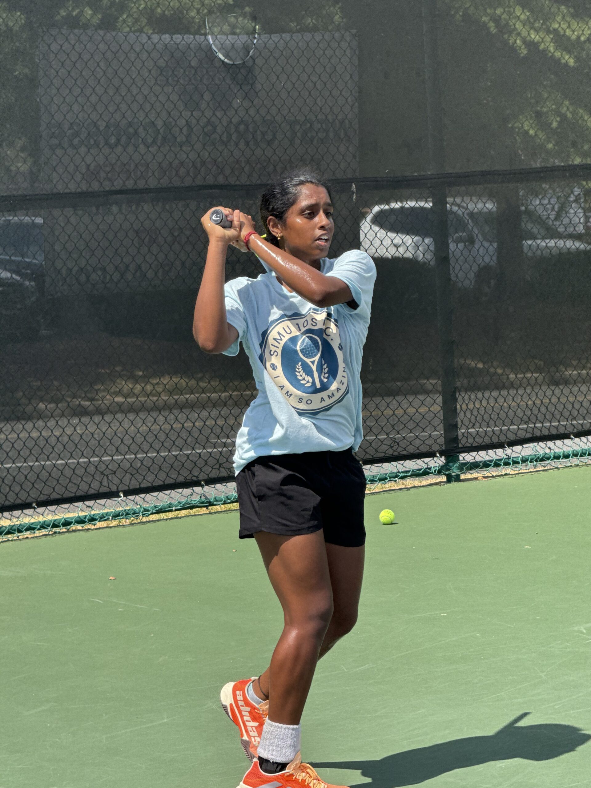 Teen player following through on a backhand during training