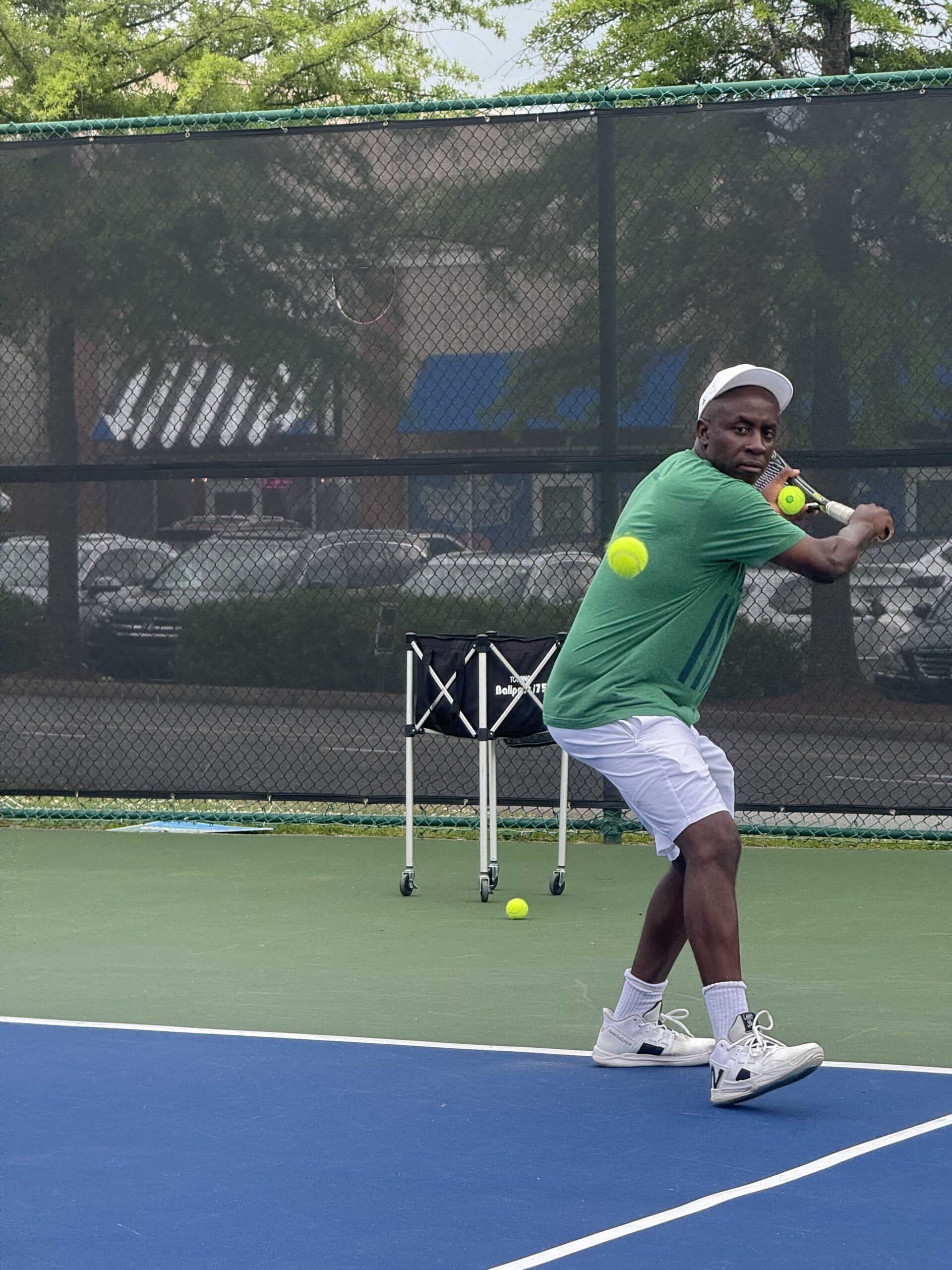 Coach Teza demonstrating backhand technique during live drill