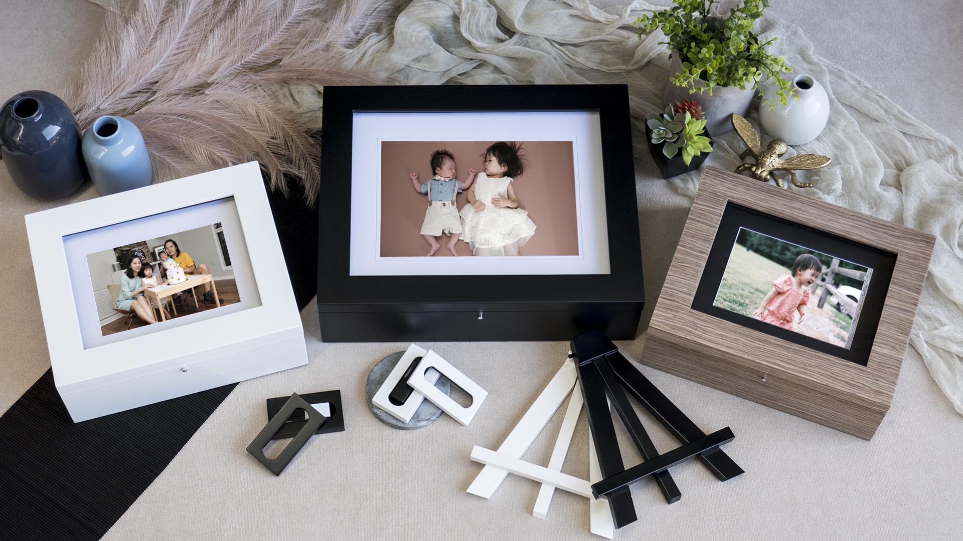Handcrafted heirloom folio reveal boxes and display easels showcasing printed family and children portraits