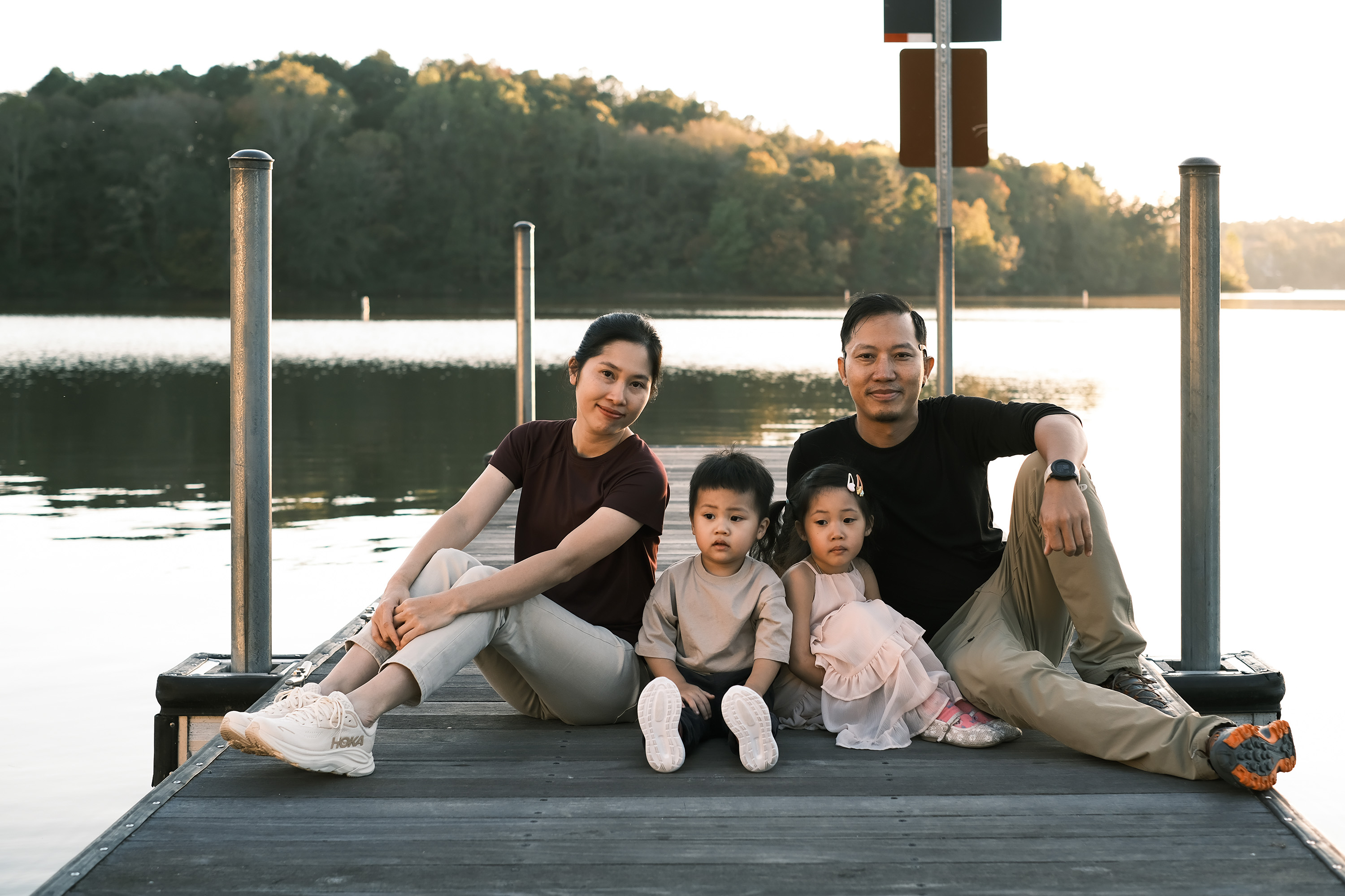Fine art family portrait on a lakeside dock during golden hour