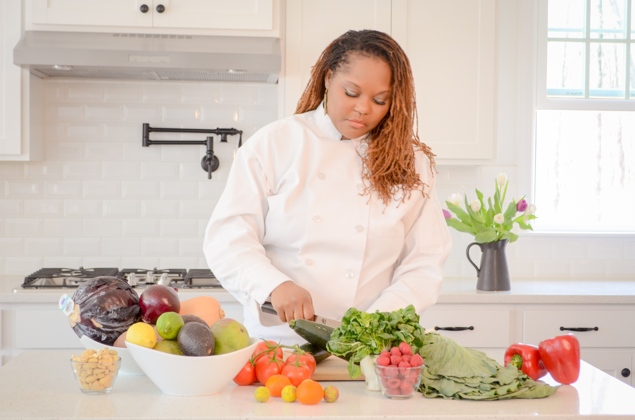 Dr. Naija preparing fresh vegetables in the kitchen.