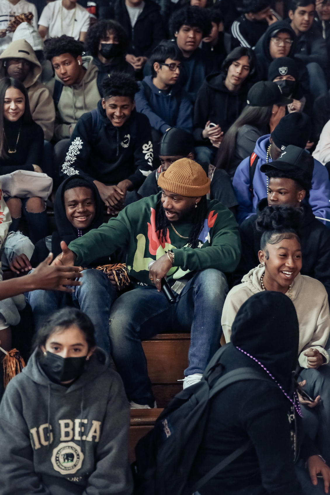 Oliver J. North connecting with students in the bleachers