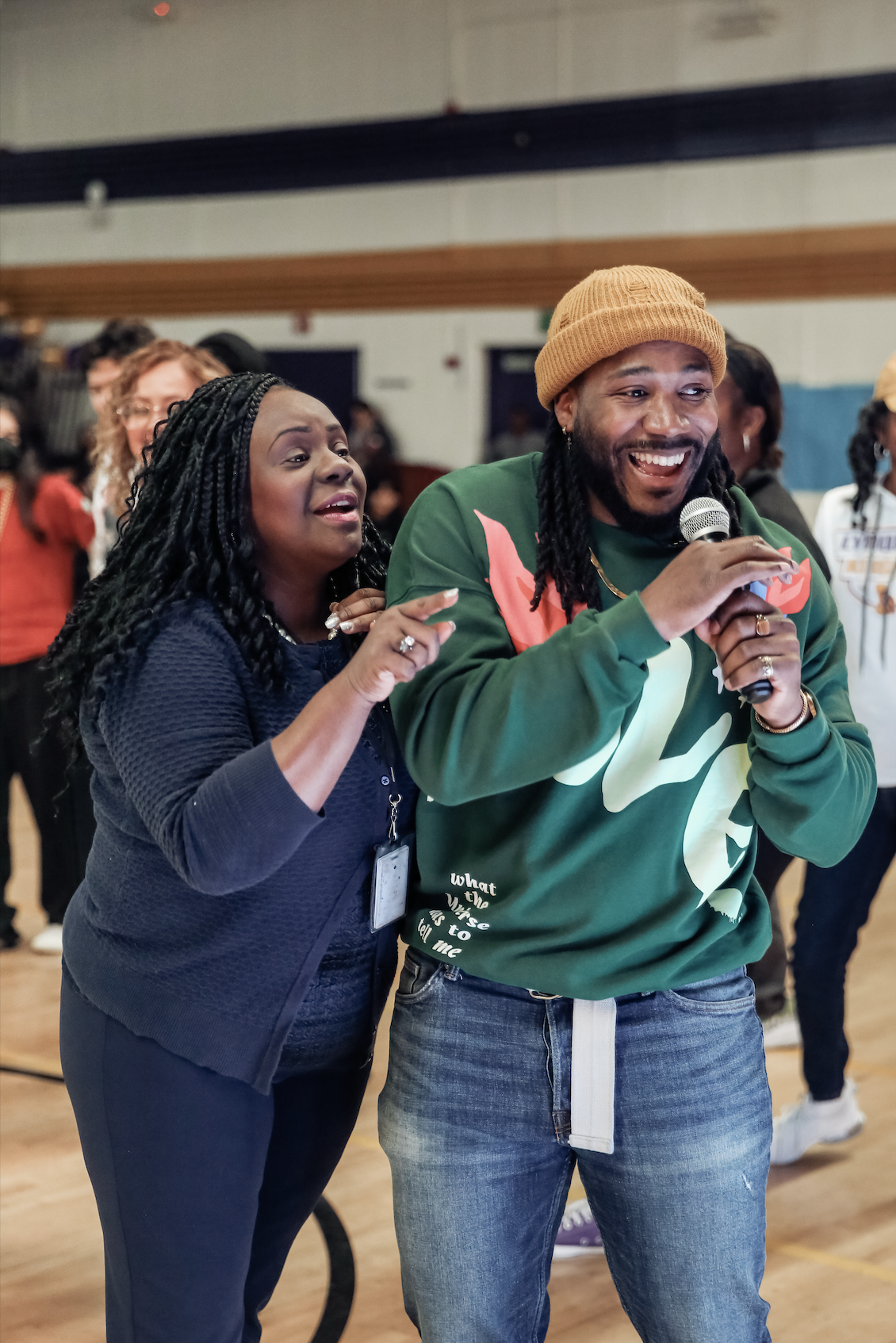 Oliver J. North sharing a joyful moment on mic with educator